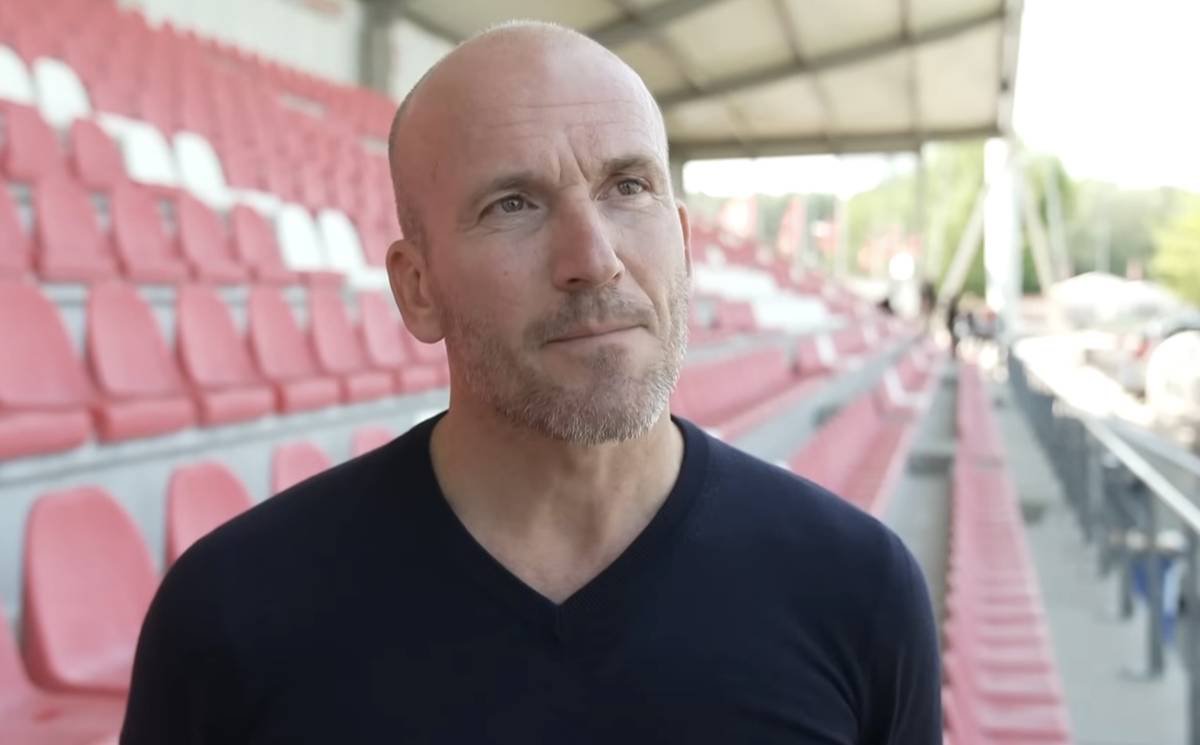 Ajax-directeur Alex Kroes tijdens een persmoment, waar zijn nieuwe koers en harde aanpak duidelijk voelbaar zijn binnen de club.