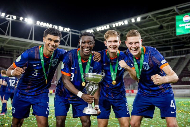 Subject: (L-R) Precious Ugwu of Holland U19, Don Angelo Konadu of Holland U19, Mark Verkuijl of Holland U19, Dies Janse of Holland U19 celebrating the EURO U19 victory with the trophy