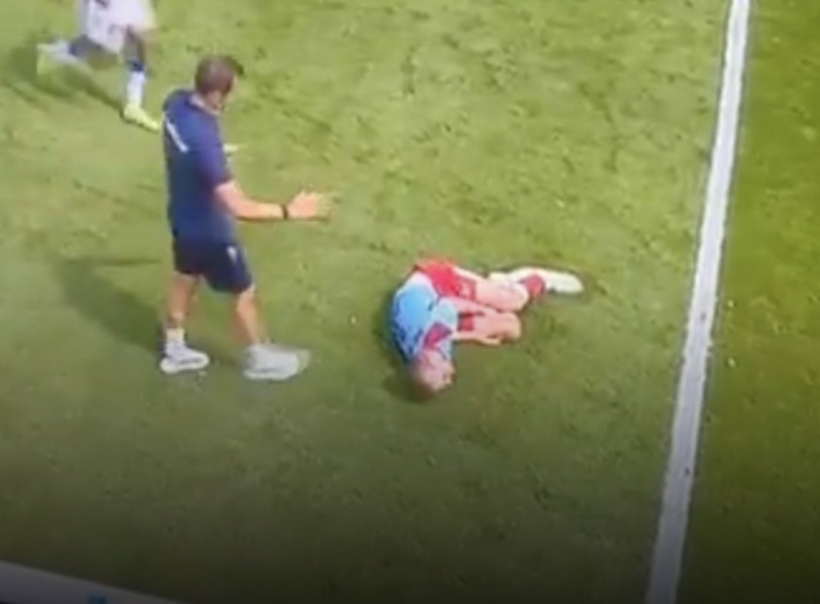 kermend van de pijn ligt thomas beelen op het veld na een overtreding op hem. de ambulance moet hem afvoeren naar het ziekenhuis